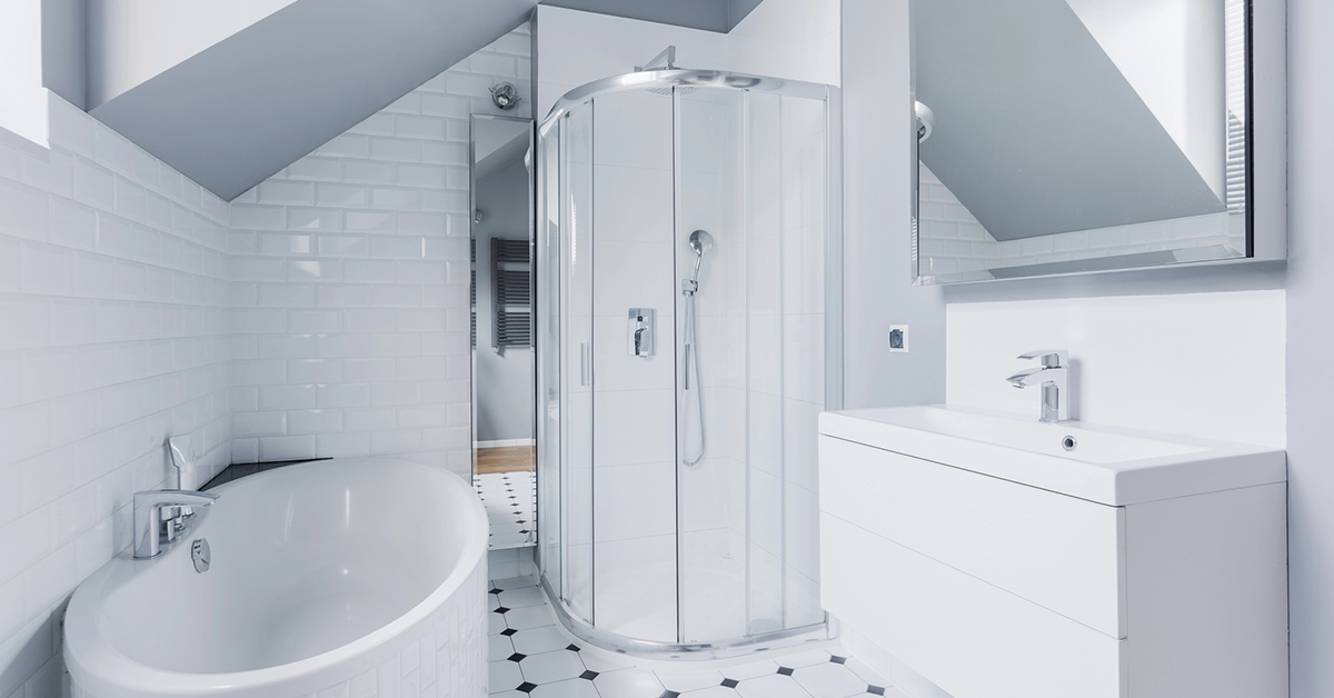 Image of a beautiful small bathroom with white tiles, flooring, and fixtures giving the illusion of a much larger space.